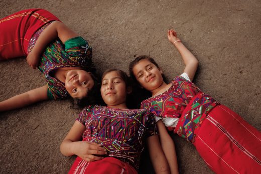 CH1668566_Delmy, 10, Maria Elena, 12, and Anabely, 11, in their school playground in Quiche district, Guatemala