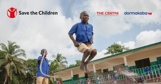 Kenie, aged 12, skipping with friends outside his school