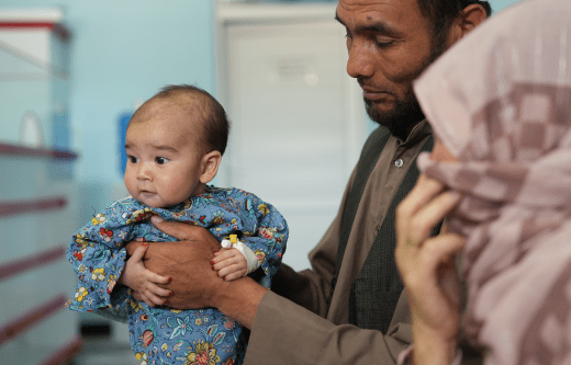 CH11031462_Firoz (11M) in arms of his father (Bashir) in the TFU supported through Save the Children.