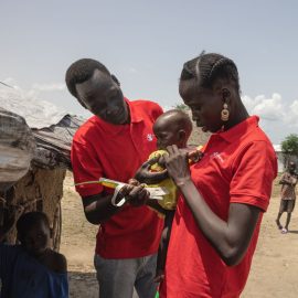 Community Nutrition Worker Nyawany, 27, visits one-year-old Machar, who is receiving treatment for S.A.M, at her home in Akobo West, South Sudan